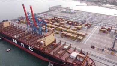 A massive container ship navigates the Panama Canal, crucial for global shipping and trade.