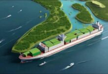 A modern container ship sailing on the ocean, representing green maritime routes.