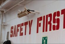 A massive container ship navigates open waters, symbolizing efficient and safe global maritime operations.