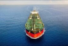 A large tanker ship navigates the ocean, central to shipping decarbonization discussions.