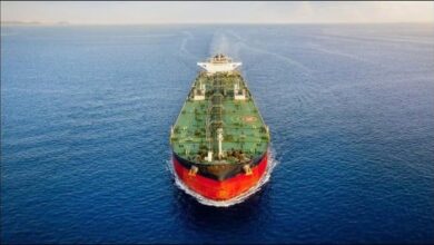 A large tanker ship navigates the ocean, central to shipping decarbonization discussions.