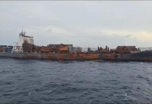 Fire-damaged Wan Hai 503 containership undergoing salvage and cargo offloading.