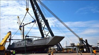 Austal USA's Navy LCU 1710 vessel launching into the water at a shipyard.