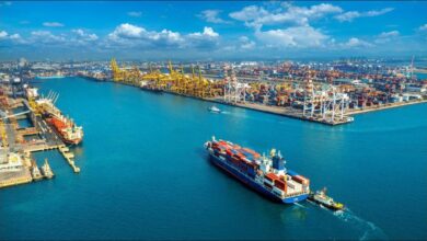 A large container ship navigates the ocean, representing global shipping finance.