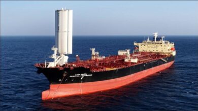 An HMM wind-assisted tanker with large vertical wing sails sailing at sea.