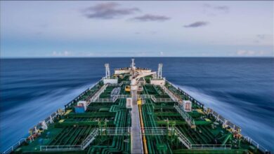 A modern container ship sails on the ocean, central to maritime emissions and compliance.
