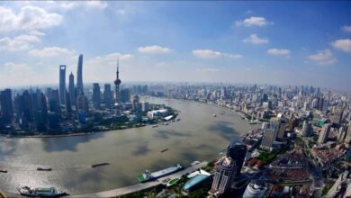 An offshore wind turbine with the bp logo is installed by a specialized carrier at sea.