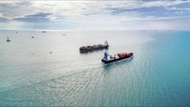 A large container ship navigates the open sea, relevant to Red Sea shipping concerns.