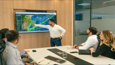 Illuminated ships and port cranes at night, representing the marine fuel industry.
