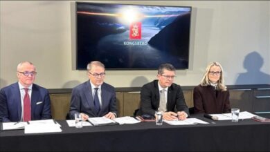 Large cargo ship with Kongsberg branding on its hull at sea.