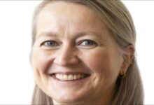 Shipowner Chavalit Tsao stands on a ship's bridge with a port in the background.
