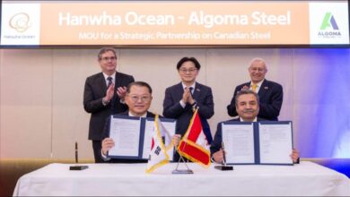 Executives from Algoma Steel and Hanwha Ocean sign a memorandum of understanding.