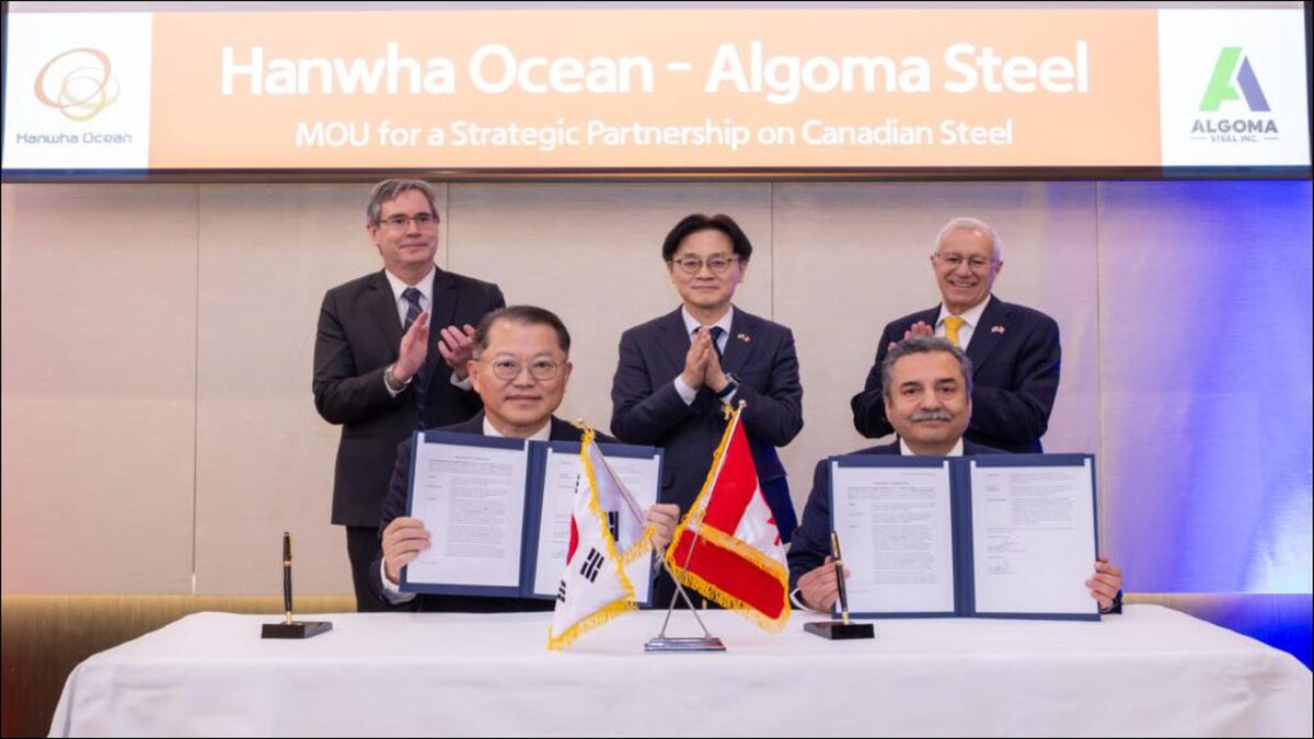 Executives from Algoma Steel and Hanwha Ocean sign a memorandum of understanding.