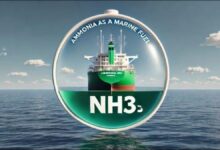 Large cargo ship with prominent green tanks on deck, likely an ammonia-fueled vessel.