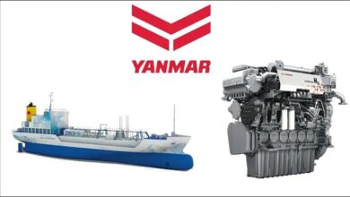 A large, industrial Yanmar hydrogen-powered engine with blue casing in a facility.