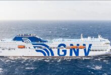 The GNV AURORA, a large white LNG-powered passenger ferry, sails on calm water.