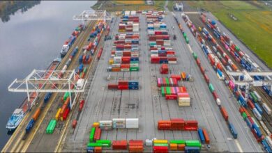 Container ships and cranes at a busy port terminal in Le Havre, France.
