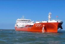 A massive oil supertanker navigates the ocean, representing global shipping.