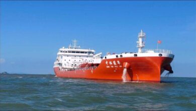 A massive oil supertanker navigates the ocean, representing global shipping.