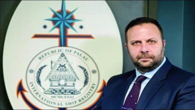 A large container ship with stacked cargo containers sails on water, representing maritime operations.