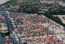 A large container ship navigates the locks of the Panama Canal, a vital shipping route.