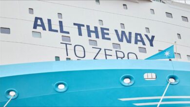 A large container ship moves through a port, representing EU maritime regulations impacting freight.