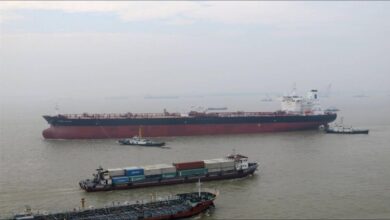 A massive oil supertanker sails on the open ocean.