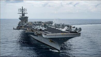 Several large container ships navigate a shipping lane amid Red Sea rerouting.