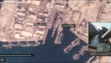An Iranian Navy ship, under construction, capsized on its side in a dry dock.