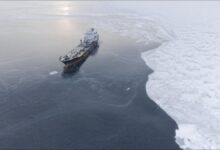 An ice-strengthened tanker navigating through icy Arctic waters.