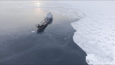 An ice-strengthened tanker navigating through icy Arctic waters.