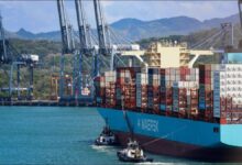 A large Maersk container ship transiting through the Panama Canal.