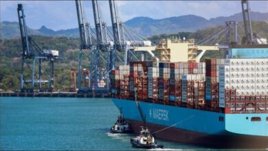 A large Maersk container ship transiting through the Panama Canal.