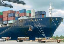 A dry bulk cargo ship loads grain at a busy Gulf Coast port.