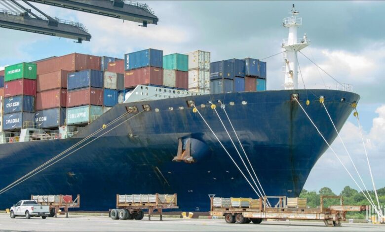 A dry bulk cargo ship loads grain at a busy Gulf Coast port.