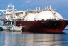 A large LNG tanker sails on the ocean, symbolizing global energy trade.