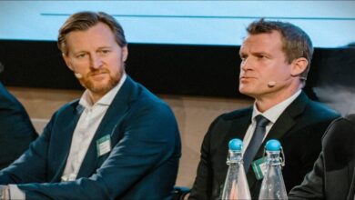 A large dry bulk carrier vessel sails on calm ocean waters.