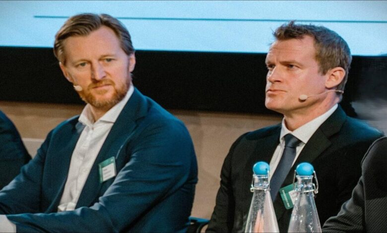 A large dry bulk carrier vessel sails on calm ocean waters.
