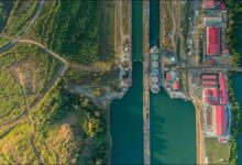 A large bulk carrier ship transits the Panama Canal, enhancing agricultural trade.