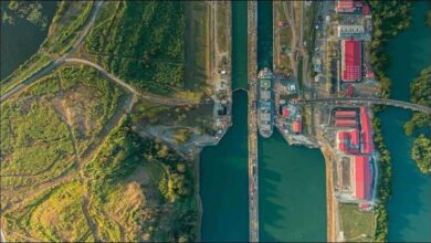 A large bulk carrier ship transits the Panama Canal, enhancing agricultural trade.