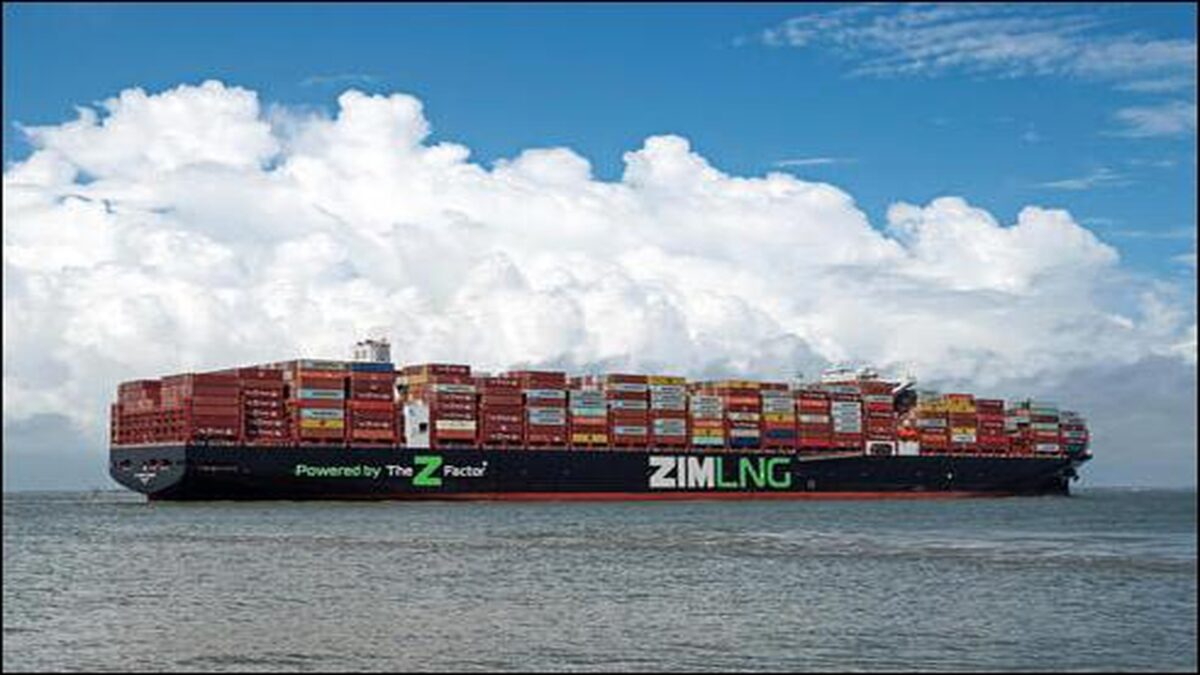 A large Zim container ship, laden with cargo, sails on the ocean.