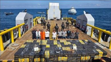 El Salvador Navy personnel alongside enormous bales of the record 6.6-tonne cocaine bust.