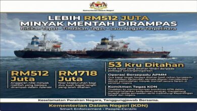 Two large tankers at sea are close together, suggesting a ship-to-ship transfer operation.