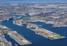 Panoramic view of a bustling Port of Los Angeles at sunset, with container ships and gantry cranes.