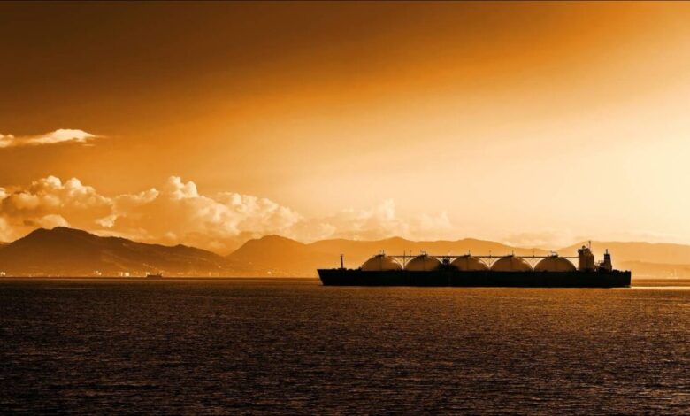 A large LNG carrier ship with distinctive spherical tanks sailing on open water.