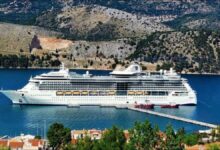 Royal Caribbean's Brilliance of the Seas cruise ship at a sunny Greek port.