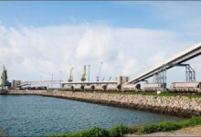 A.P. Moller Capital grain terminal in Morocco, with large silos and port infrastructure.