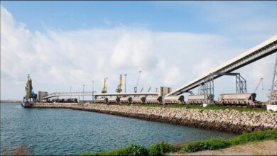 A.P. Moller Capital grain terminal in Morocco, with large silos and port infrastructure.