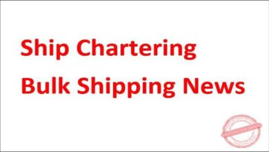 A large bulk carrier vessel navigates a busy shipping lane in the Panama Canal.