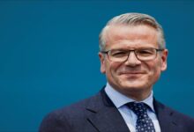 A large Maersk container ship docked at an Indian port.